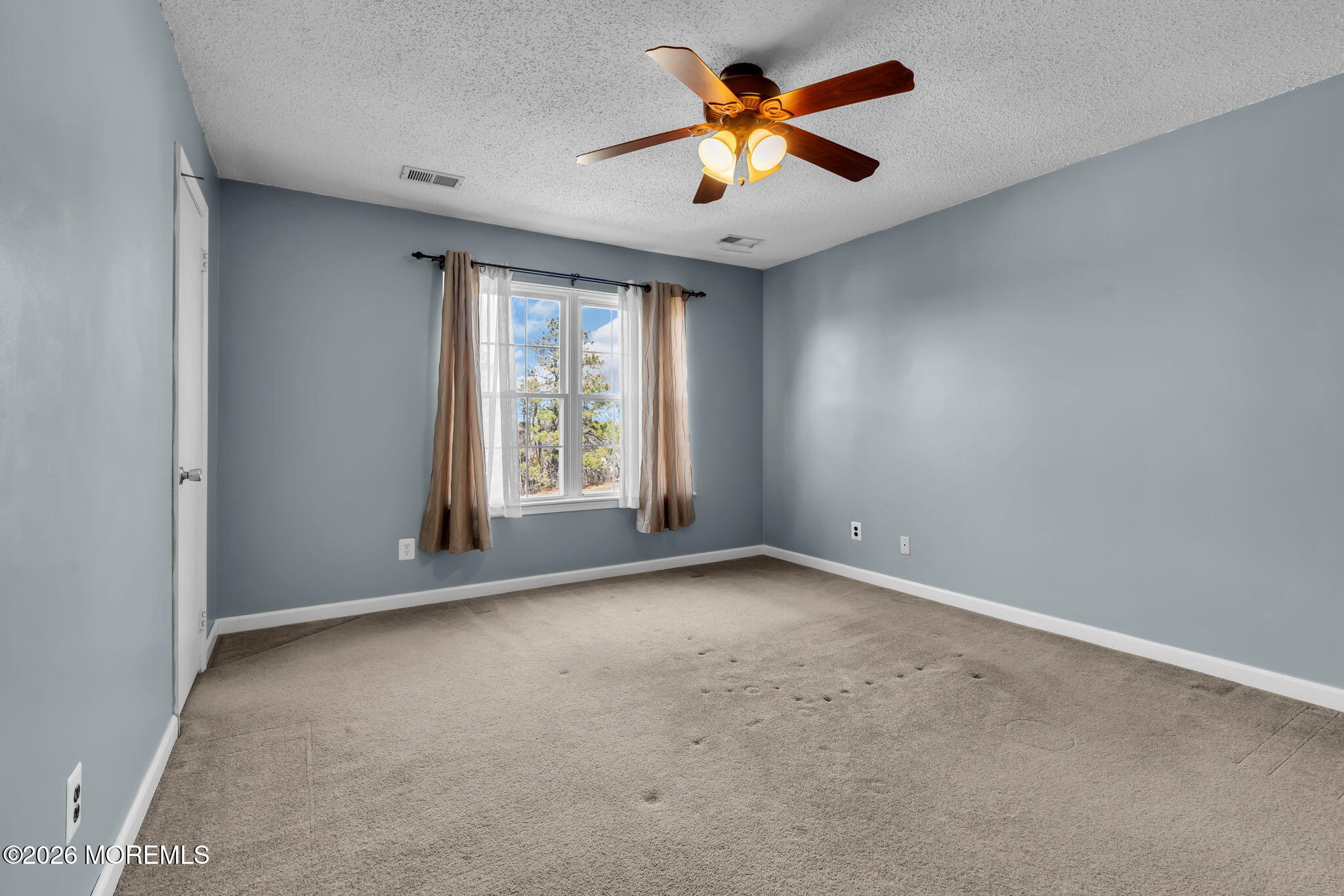 106 Frontier Way Tinton Falls, NJ 07753 - Photo 15 of 22 an empty room with a window and a ceiling fan