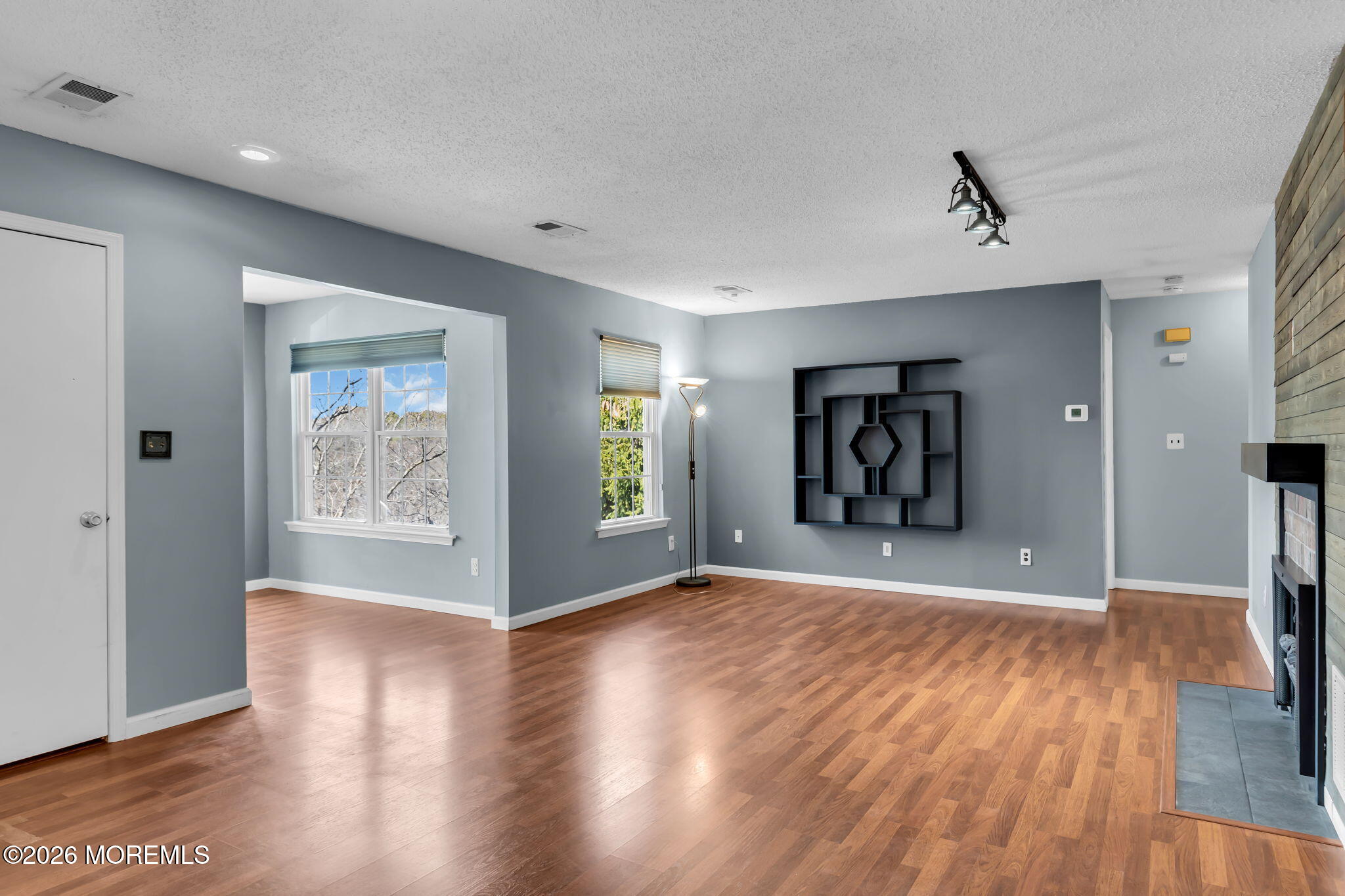 106 Frontier Way Tinton Falls, NJ 07753 - Photo 2 of 22 a view of an empty room with wooden floor and a window