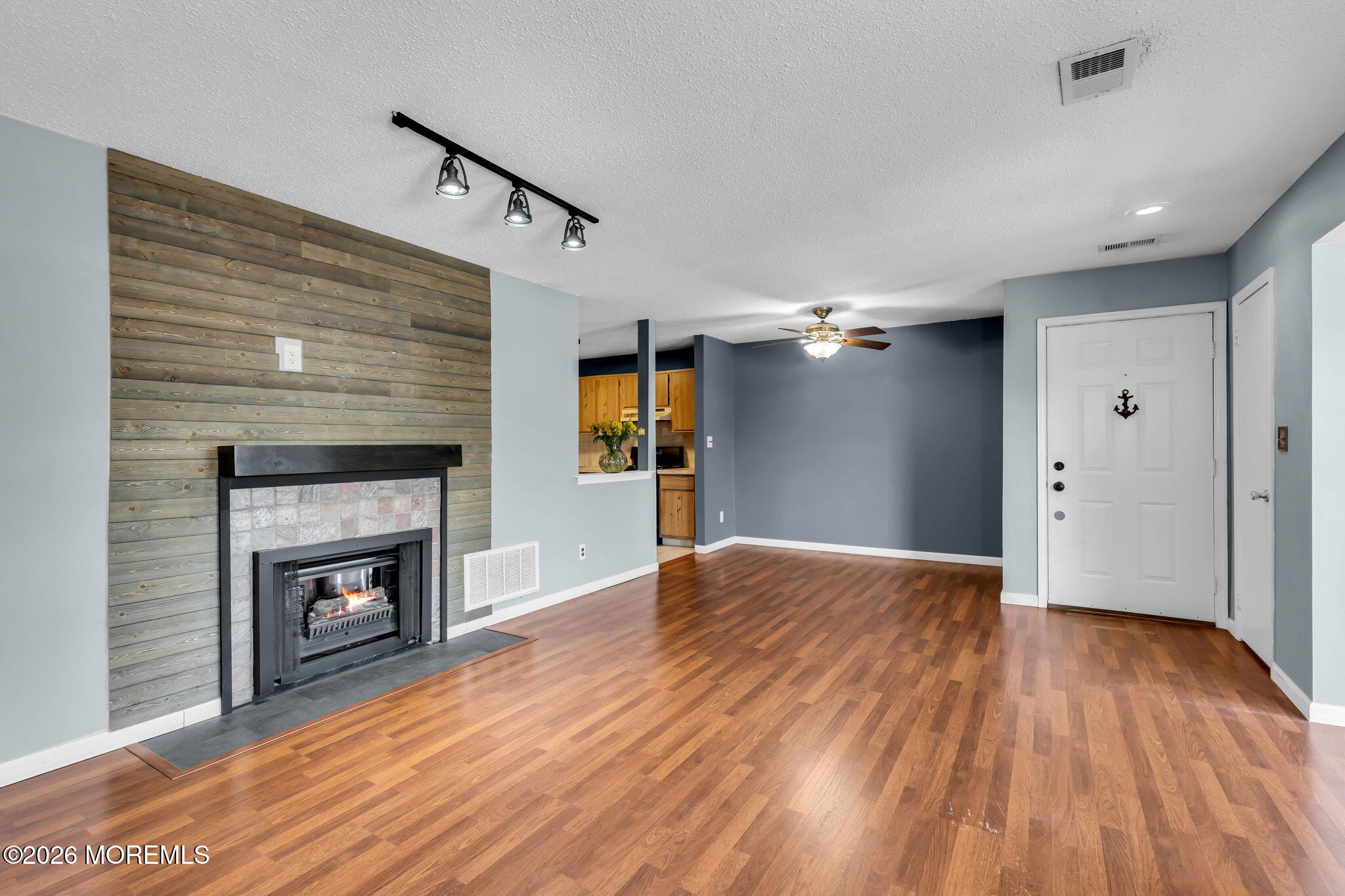 106 Frontier Way Tinton Falls, NJ 07753 - Photo 3 of 22 a view of empty room with wooden floor and fireplace