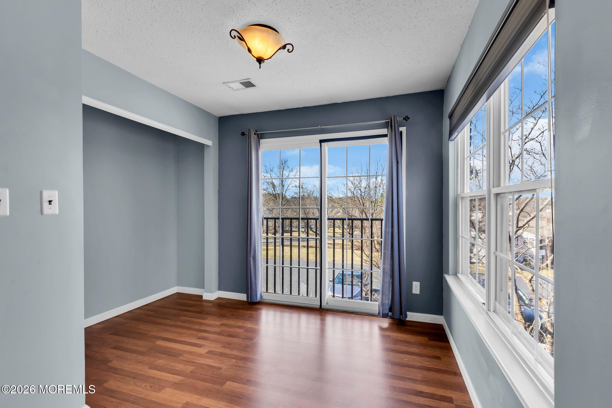 106 Frontier Way Tinton Falls, NJ 07753 - Photo 5 of 22 a view of an empty room with a window and wooden floor