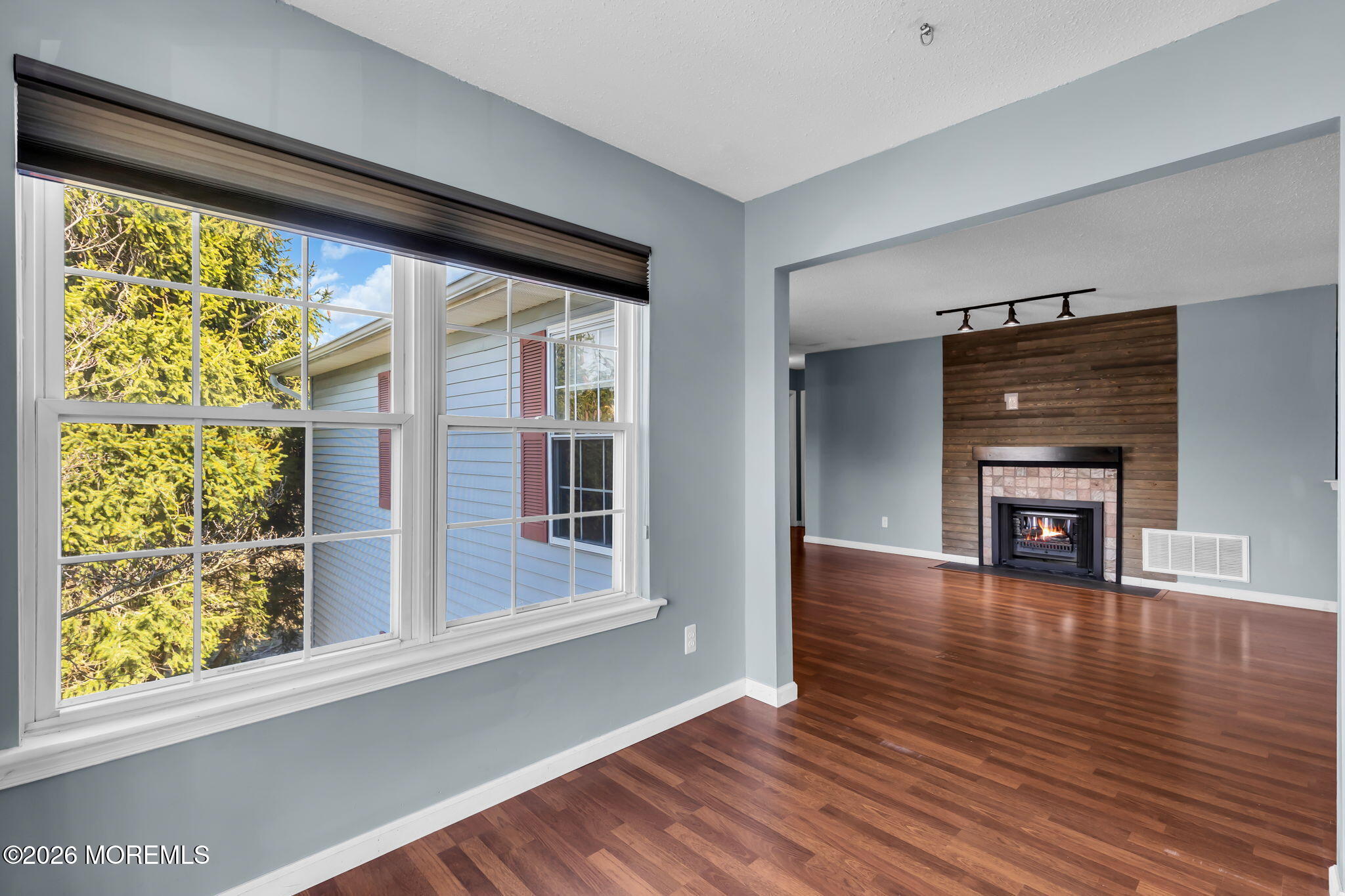 106 Frontier Way Tinton Falls, NJ 07753 - Photo 6 of 22 a view of empty room with wooden floor and fireplace