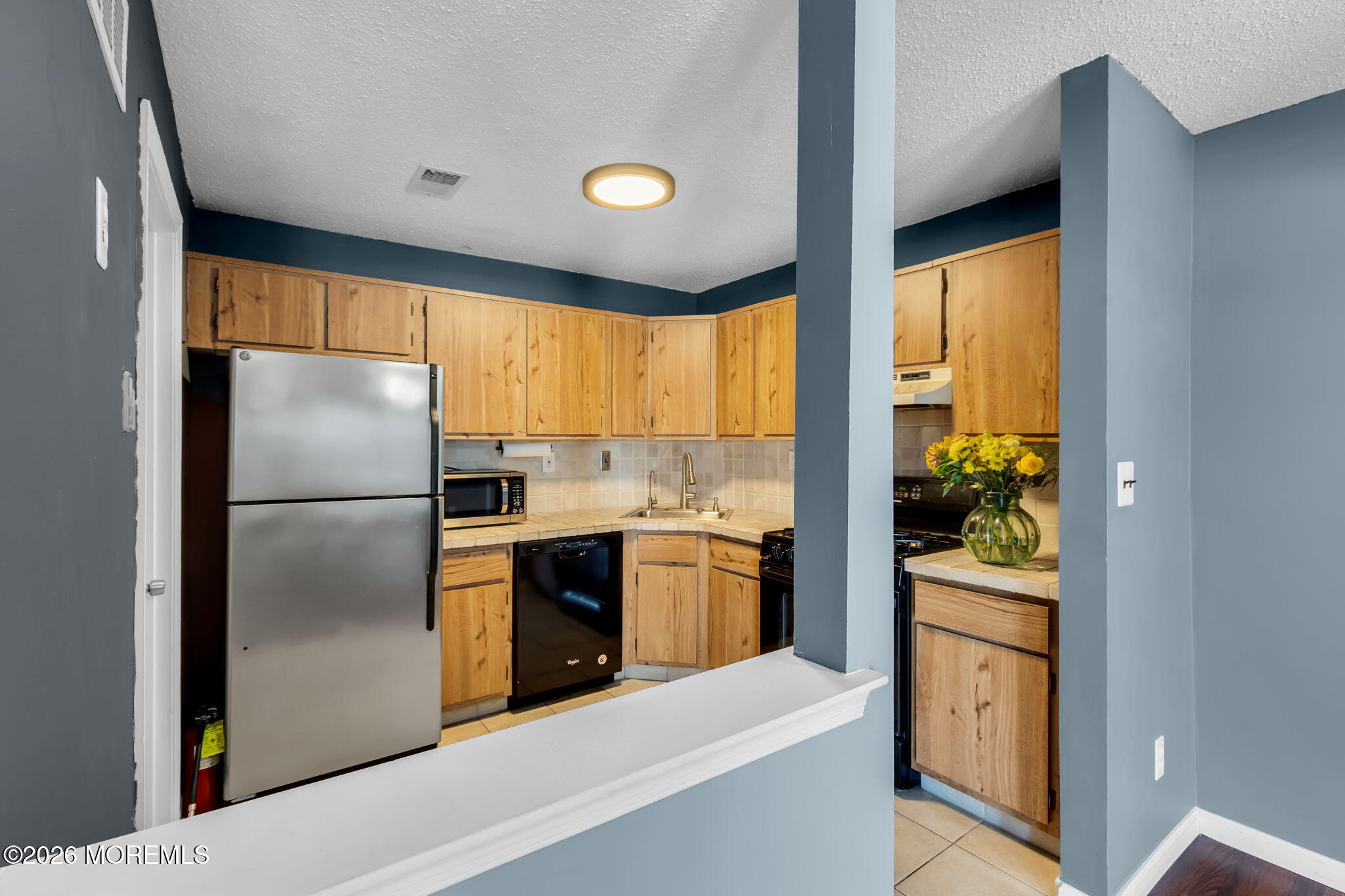 106 Frontier Way Tinton Falls, NJ 07753 - Photo 8 of 22 a kitchen with a refrigerator and a stove