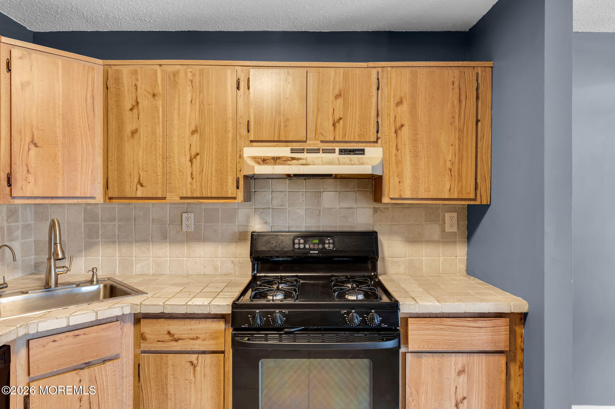 106 Frontier Way Tinton Falls, NJ 07753 - Photo 10 of 22 a kitchen with granite countertop a stove sink and cabinets