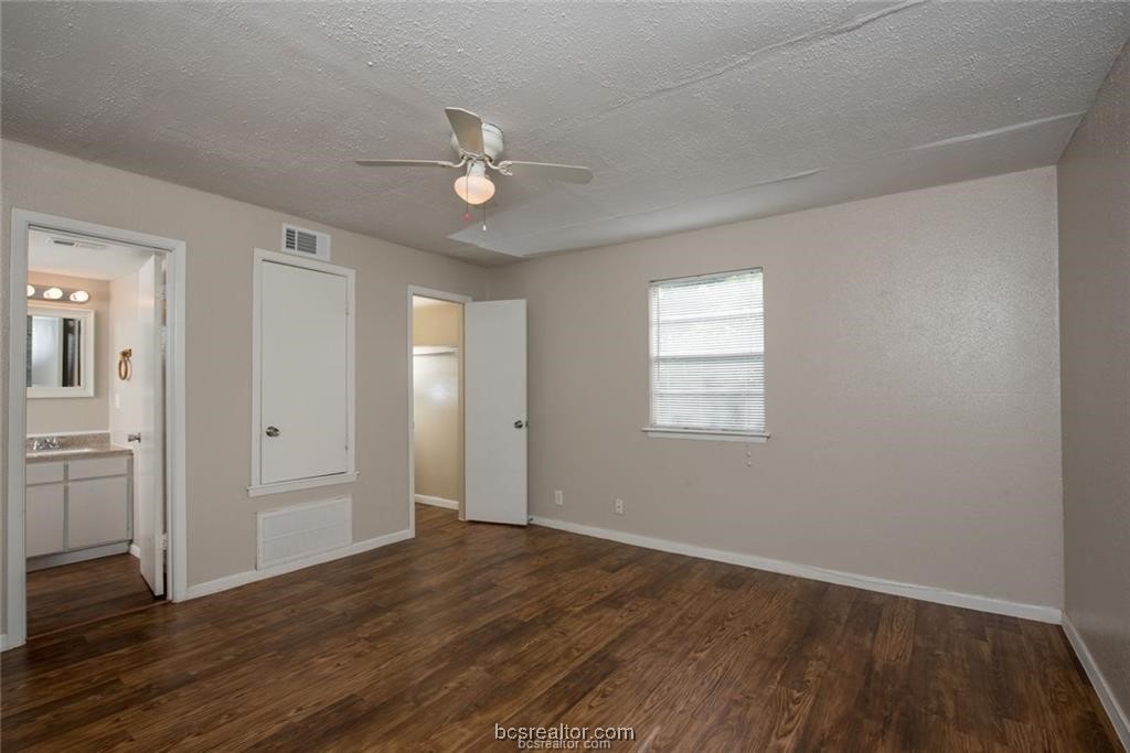 3900 Old College Road, Unit 17 Bryan, TX 77801 - Photo 8 of 11 an empty room with wooden floor and windows