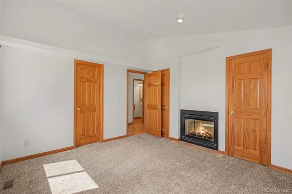 a view of empty room with a fireplace