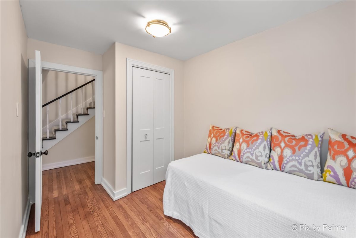 712 South 5th Street St. Charles, IL 60174 - Photo 15 of 25 a bedroom with a bed and wooden floor
