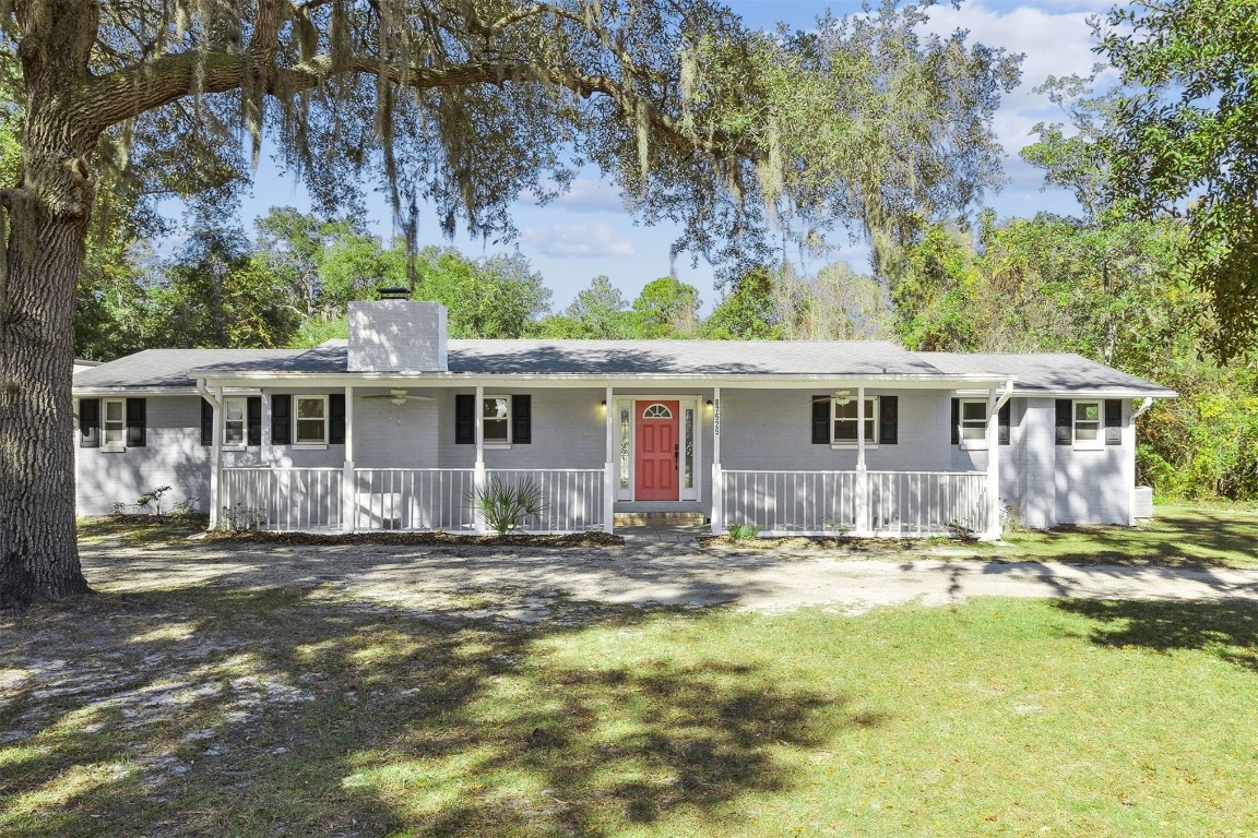 87529 Roses Bluff Road Yulee, FL 32097 - Photo 1 of 38 a front view of a house with a yard