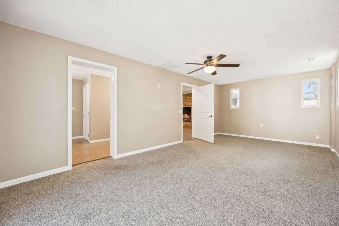 87529 Roses Bluff Road Yulee, FL 32097 - Photo 17 of 38 a view of an empty room with a ceiling fan