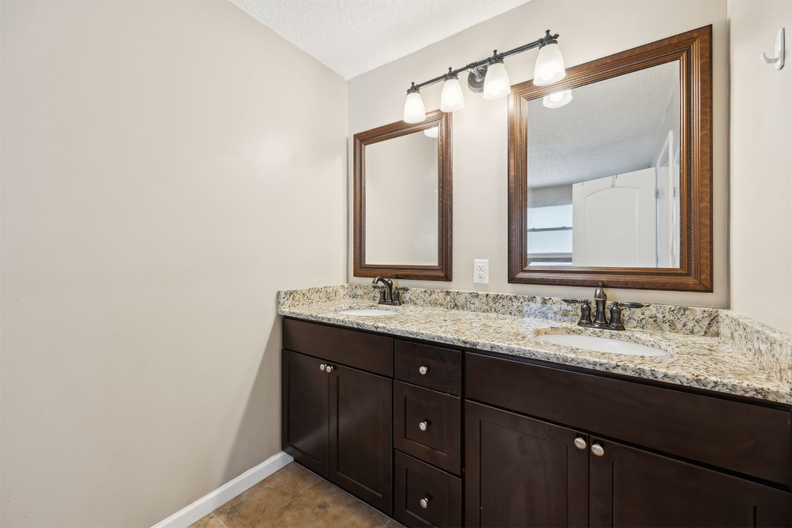 87529 Roses Bluff Road Yulee, FL 32097 - Photo 18 of 38 a bathroom with a double vanity sink and a mirror