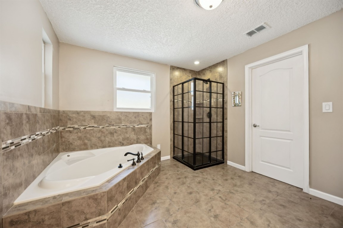 87529 Roses Bluff Road Yulee, FL 32097 - Photo 19 of 38 a bathroom with a bathtub and shower