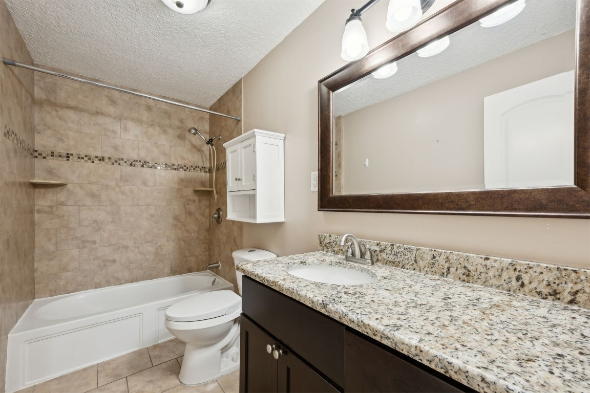 87529 Roses Bluff Road Yulee, FL 32097 - Photo 23 of 38 a bathroom with a granite countertop sink a toilet and shower