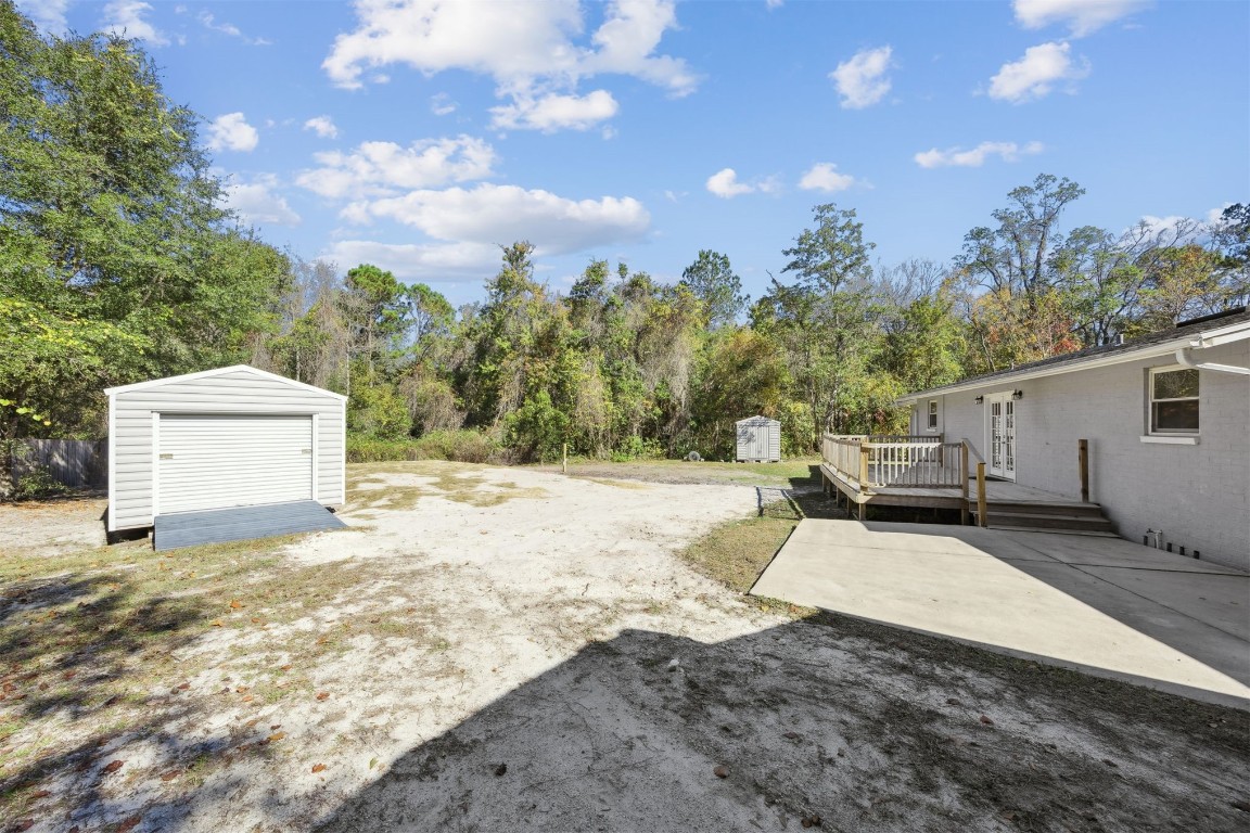 87529 Roses Bluff Road Yulee, FL 32097 - Photo 29 of 38 a white house that has a tree in front of it