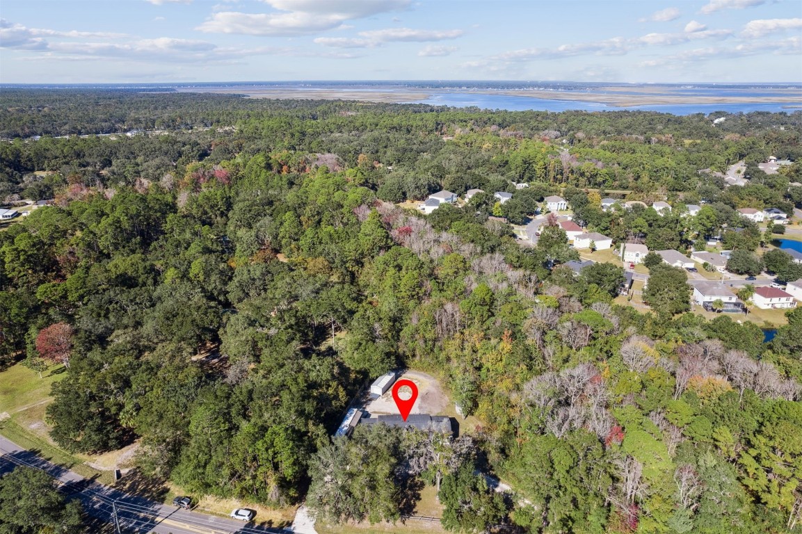 87529 Roses Bluff Road Yulee, FL 32097 - Photo 33 of 38 an aerial view of residential houses with outdoor space and trees