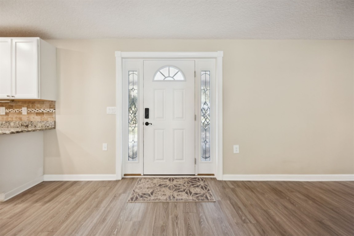 87529 Roses Bluff Road Yulee, FL 32097 - Photo 7 of 38 an empty room with wooden floor and windows