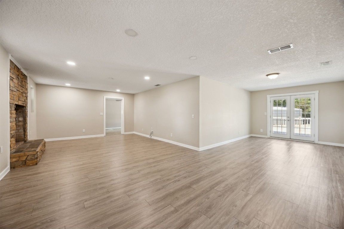 87529 Roses Bluff Road Yulee, FL 32097 - Photo 8 of 38 a view of an empty room with wooden floor and a window
