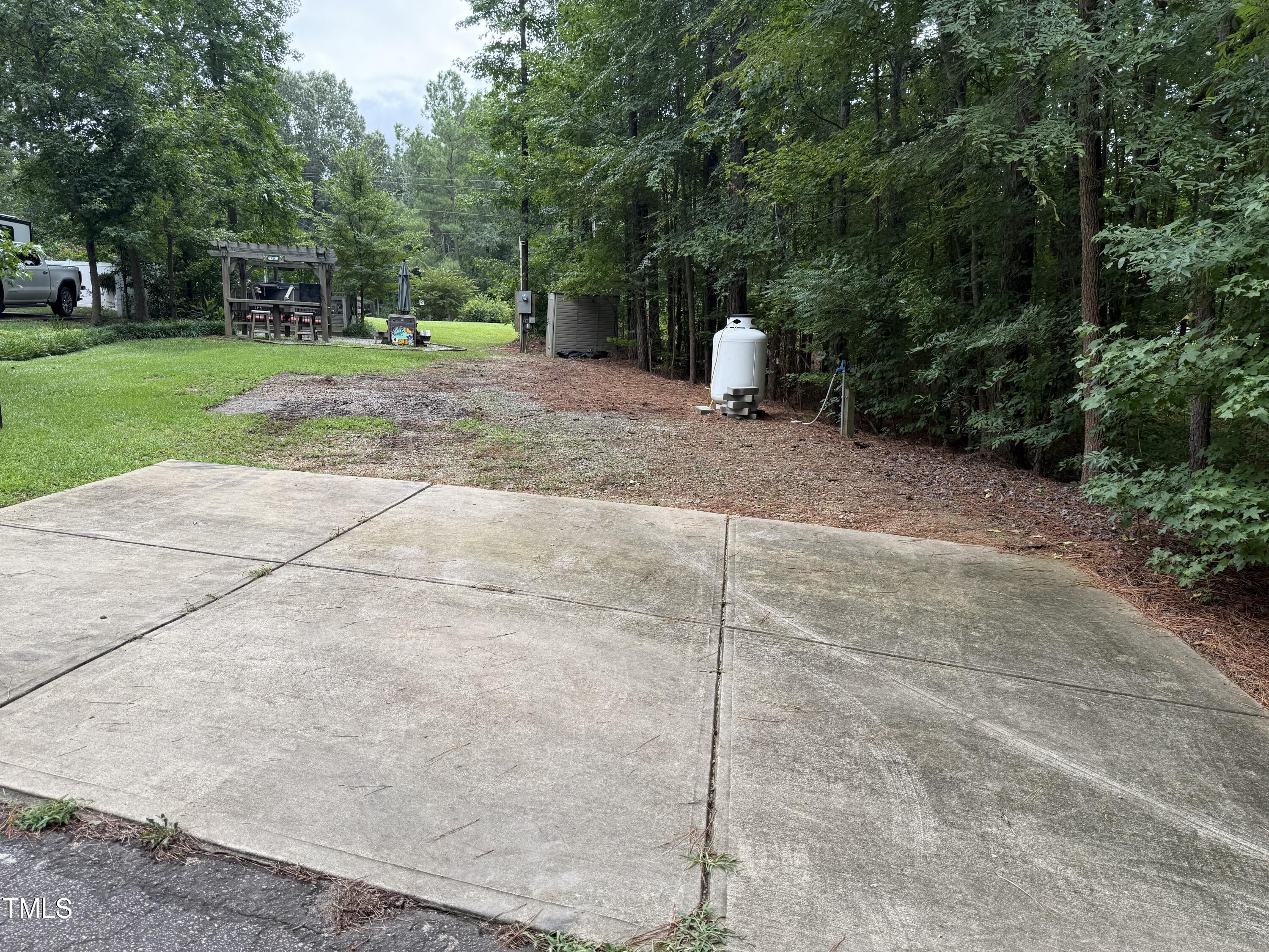 124 Kansas Drive Spring Hope, NC 27882 - Photo 9 of 10 a wooden bench sitting in the middle of a yard