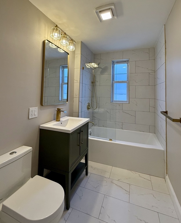 69 Conwell Avenue, Unit 2 Somerville, MA 02144 - Photo 10 of 14 a bathroom with a sink a toilet and bathtub