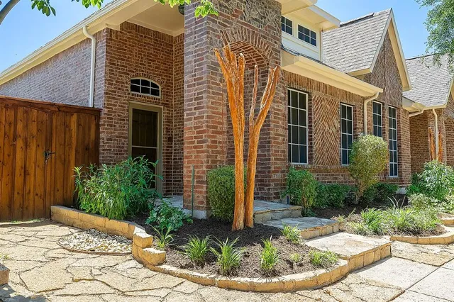 a view of a house with potted plants