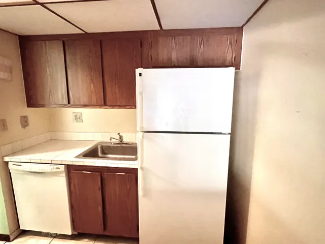 a kitchen with a sink a refrigerator and a stove