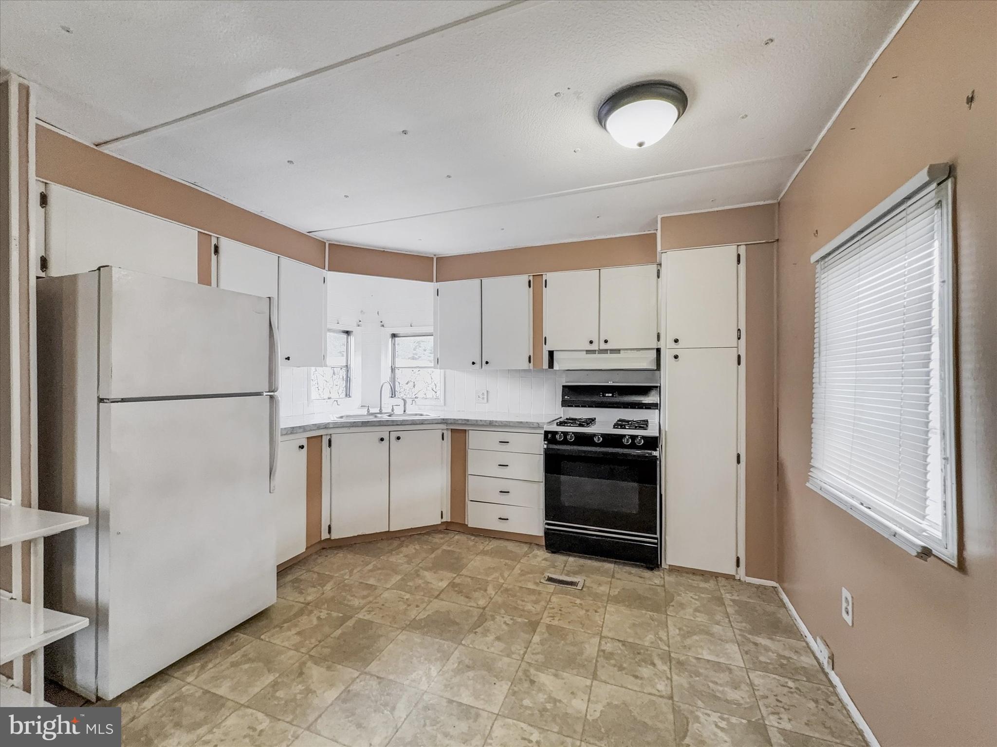 3720 Davidsburg Road, Unit C7 Dover, PA 17315 - Photo 8 of 20 a kitchen with white cabinets and refrigerator