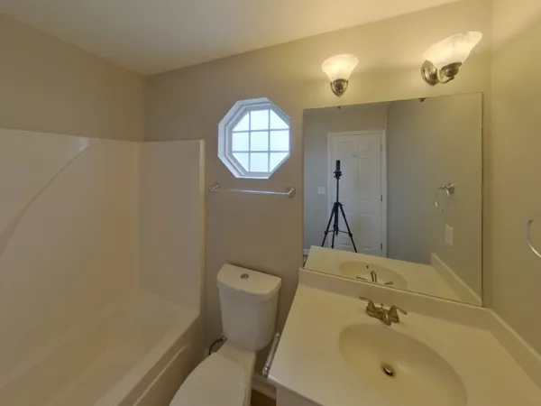 a bathroom with a toilet and a tub