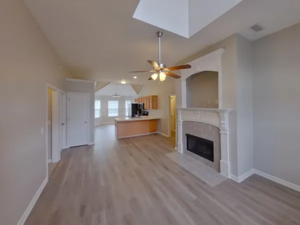 a view of a kitchen and an entryway with wooden floor