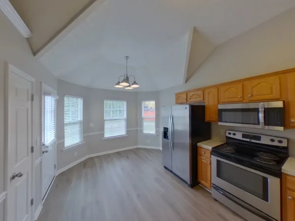 a kitchen with stainless steel appliances a stove and a refrigerator
