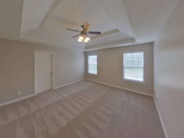 a view of empty room with windows and ceiling fan view