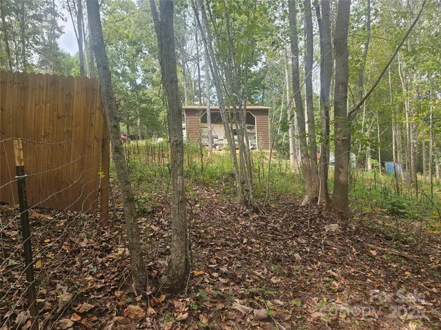 a backyard of a house with lots of green space and trees