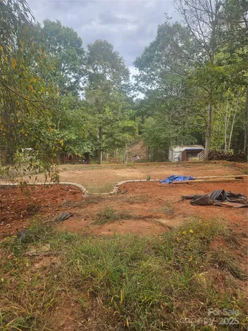 a view of a yard with large trees