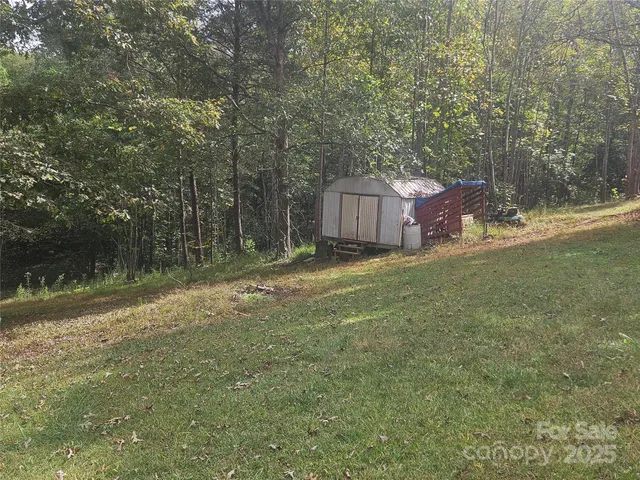 a backyard of a house with lots of green space and fountain