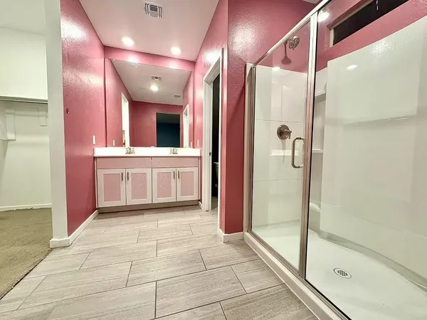 a bathroom with a bathtub and a shower