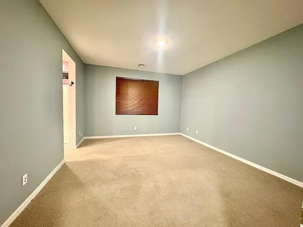 an empty room with a empty space and windows