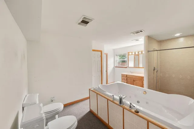 a bathroom with a granite countertop sink toilet and shower
