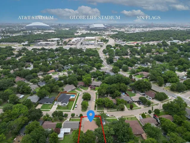 an aerial view of residential houses with outdoor space and street view