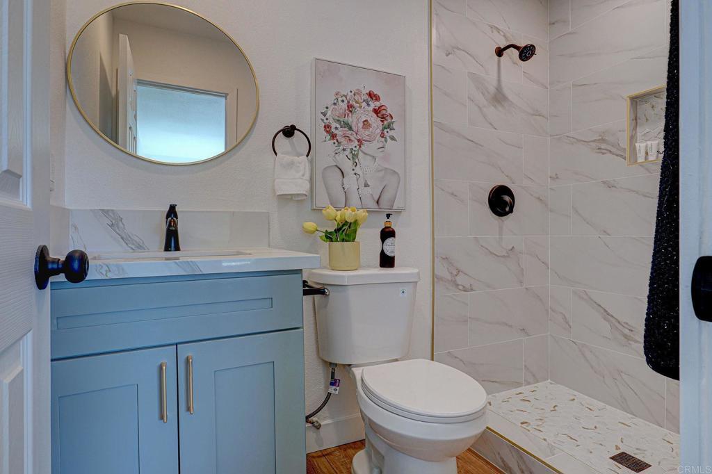 4205 Rene Drive San Diego, CA 92154 - Photo 19 of 24 a bathroom with a toilet a sink and mirror