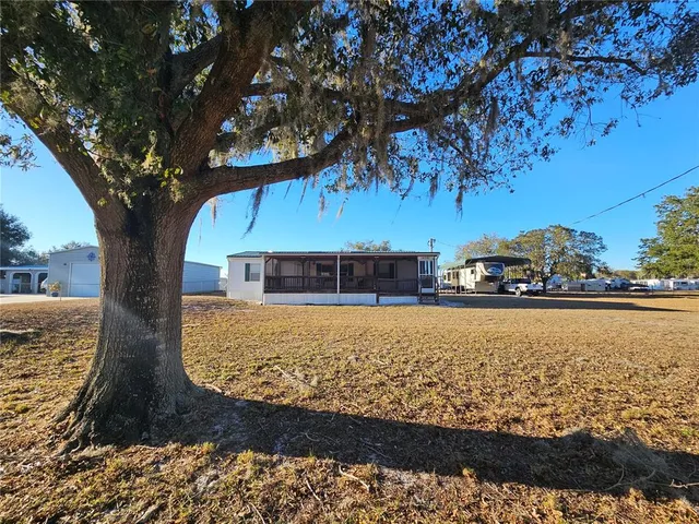 a view of a yard with an outdoor seating