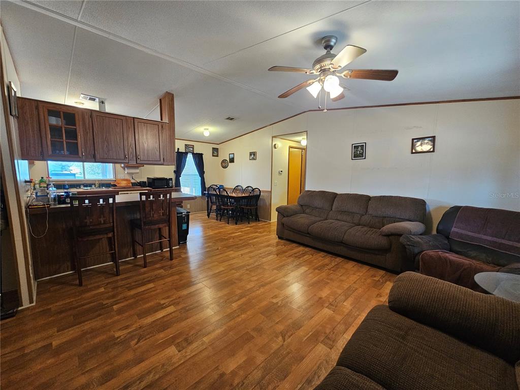 14381 Camp Mack Road Lake Wales, FL 33898 - Photo 12 of 52 a living room with stainless steel appliances furniture and a wooden floor