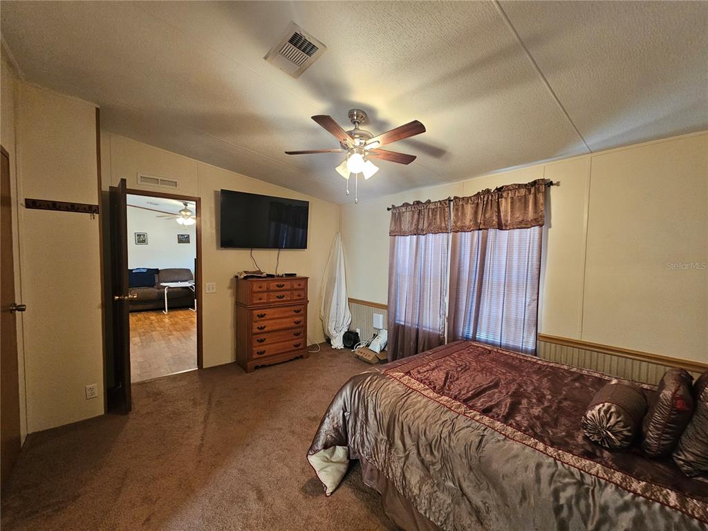 14381 Camp Mack Road Lake Wales, FL 33898 - Photo 14 of 52 a bed room with a bed and a television
