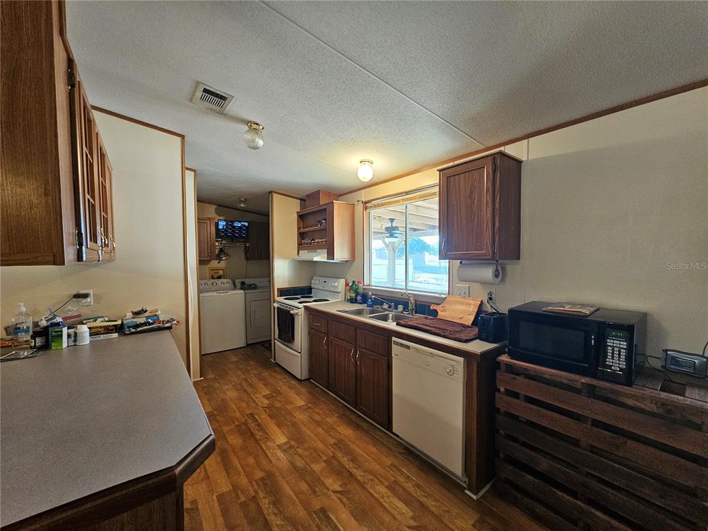 14381 Camp Mack Road Lake Wales, FL 33898 - Photo 4 of 52 a kitchen with stainless steel appliances a sink cabinets and wooden floor