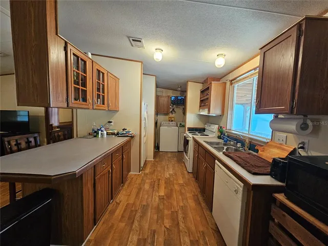 a kitchen with stainless steel appliances a sink stove and refrigerator