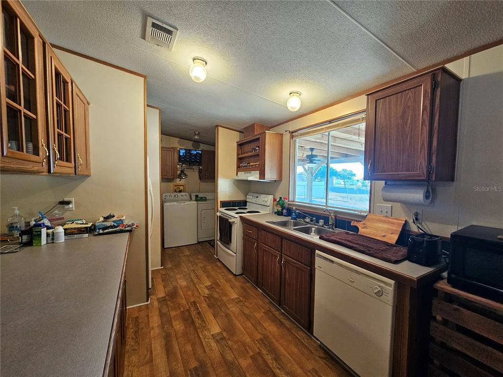 14381 Camp Mack Road Lake Wales, FL 33898 - Photo 6 of 52 a kitchen with a sink a stove a refrigerator cabinets and a window