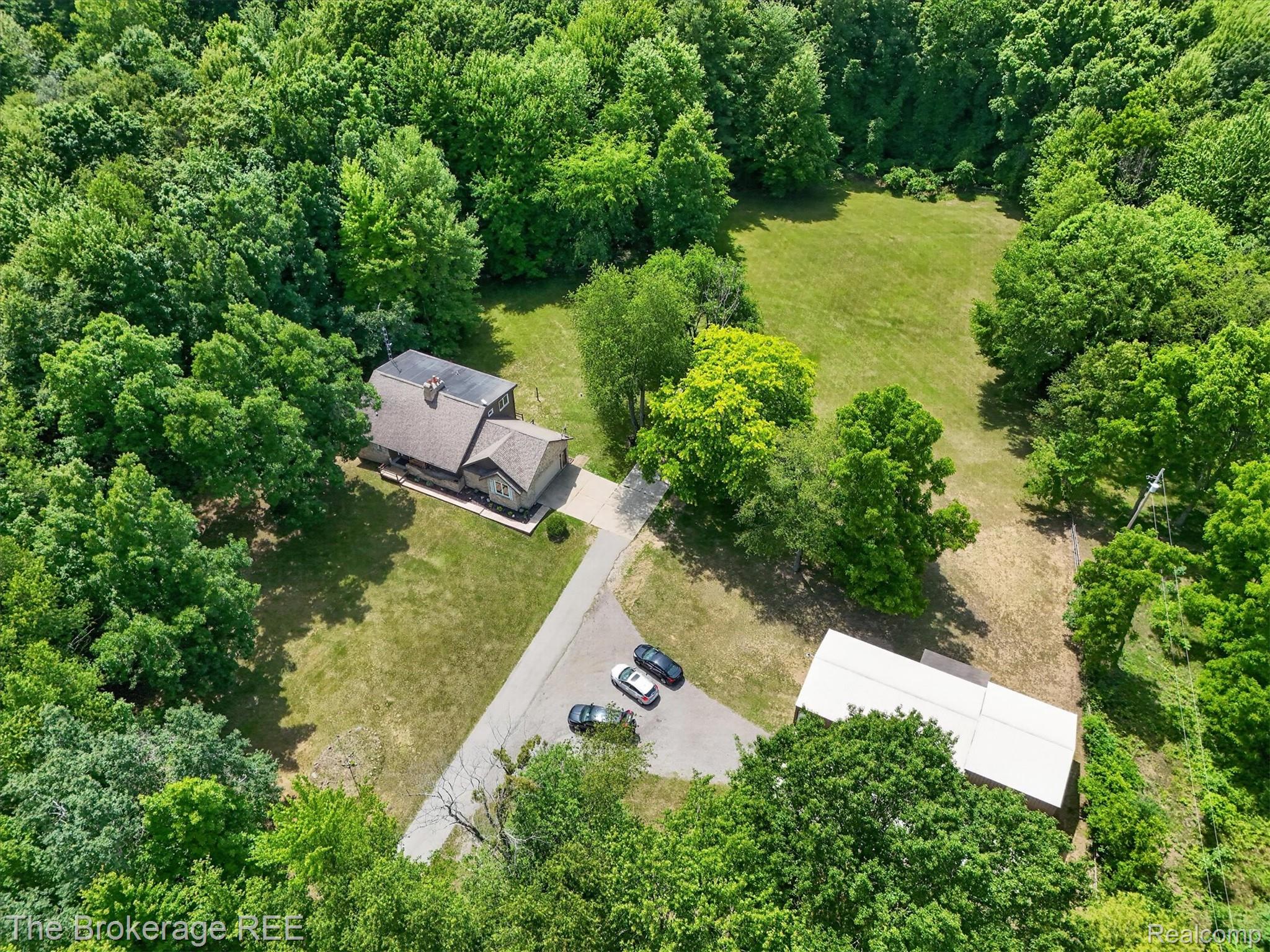 13269 North Genesee Road Clio, MI 48420 - Photo 54 of 67 Expansive property featuring a residence, detached outbuilding, ample green space, and mature trees