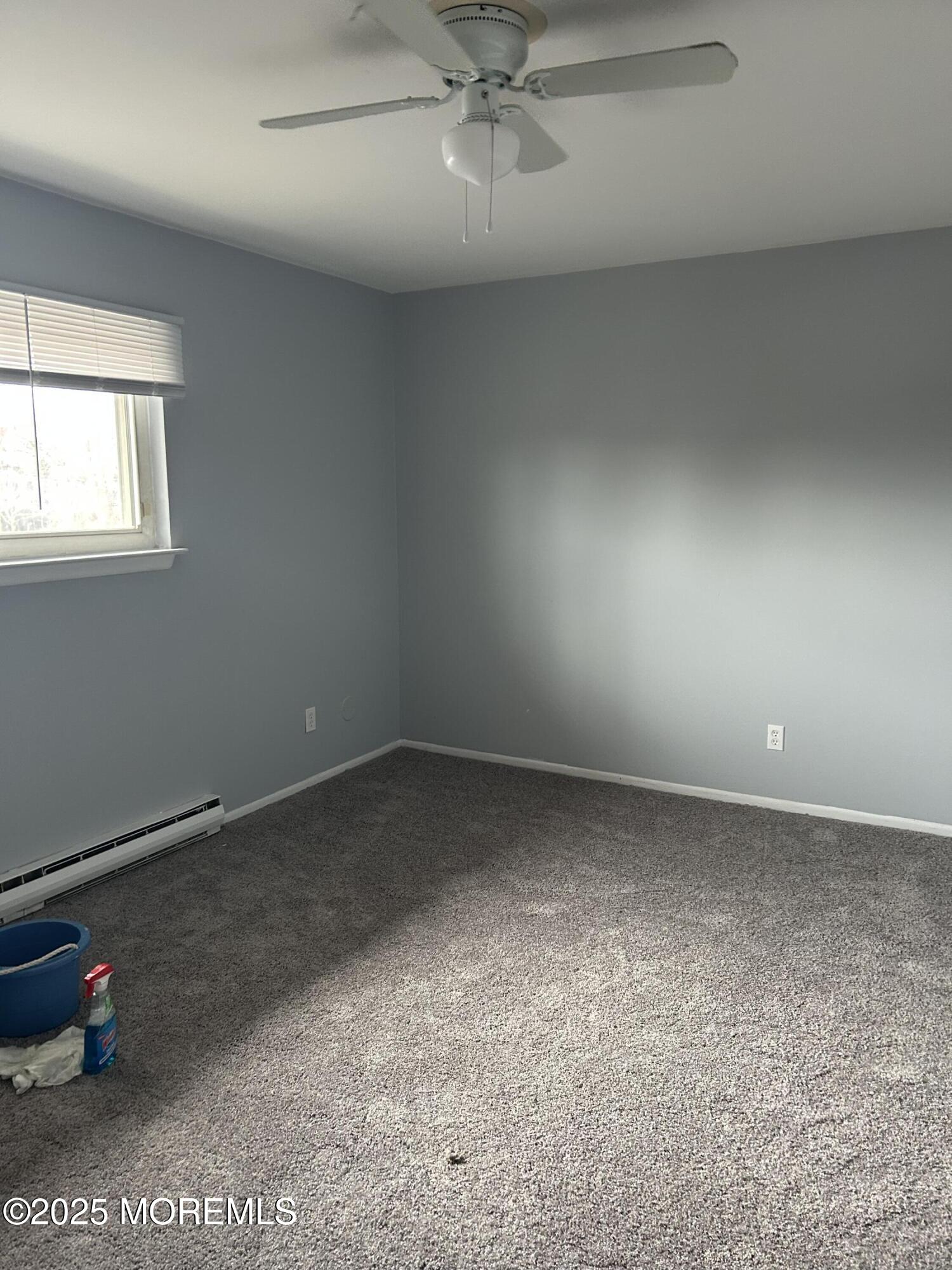 240 South Lincoln Avenue, Unit 16 Elberon, NJ 07740 - Photo 2 of 7 an empty room with a potted plant and windows