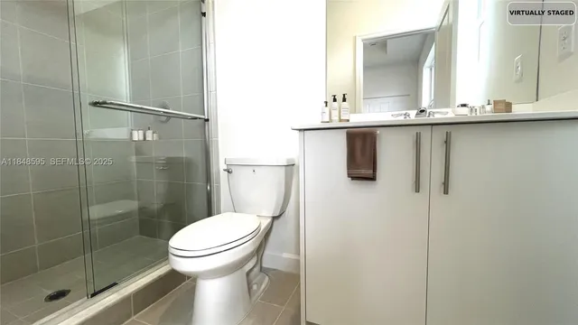a bathroom with a toilet a sink and shower