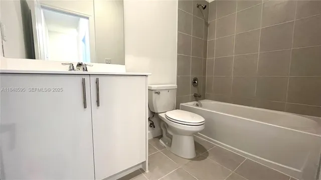 a bathroom with a toilet a sink and a mirror
