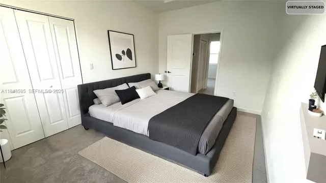 a bedroom with a bed and window