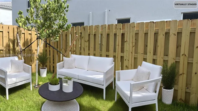 a view of a patio with a chairs and a table