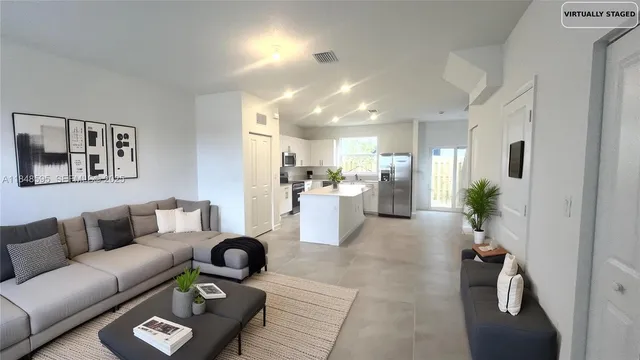 a living room with furniture and a dining table with wooden floor