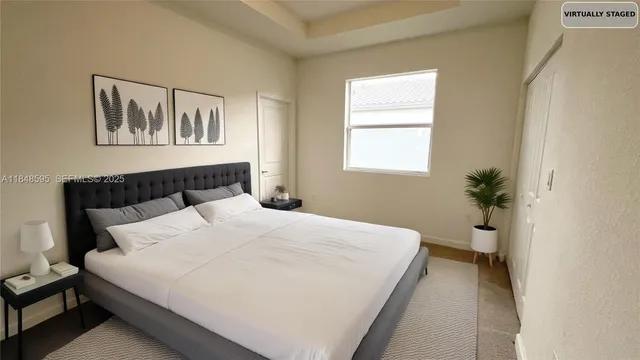 a bedroom with a large bed and a window